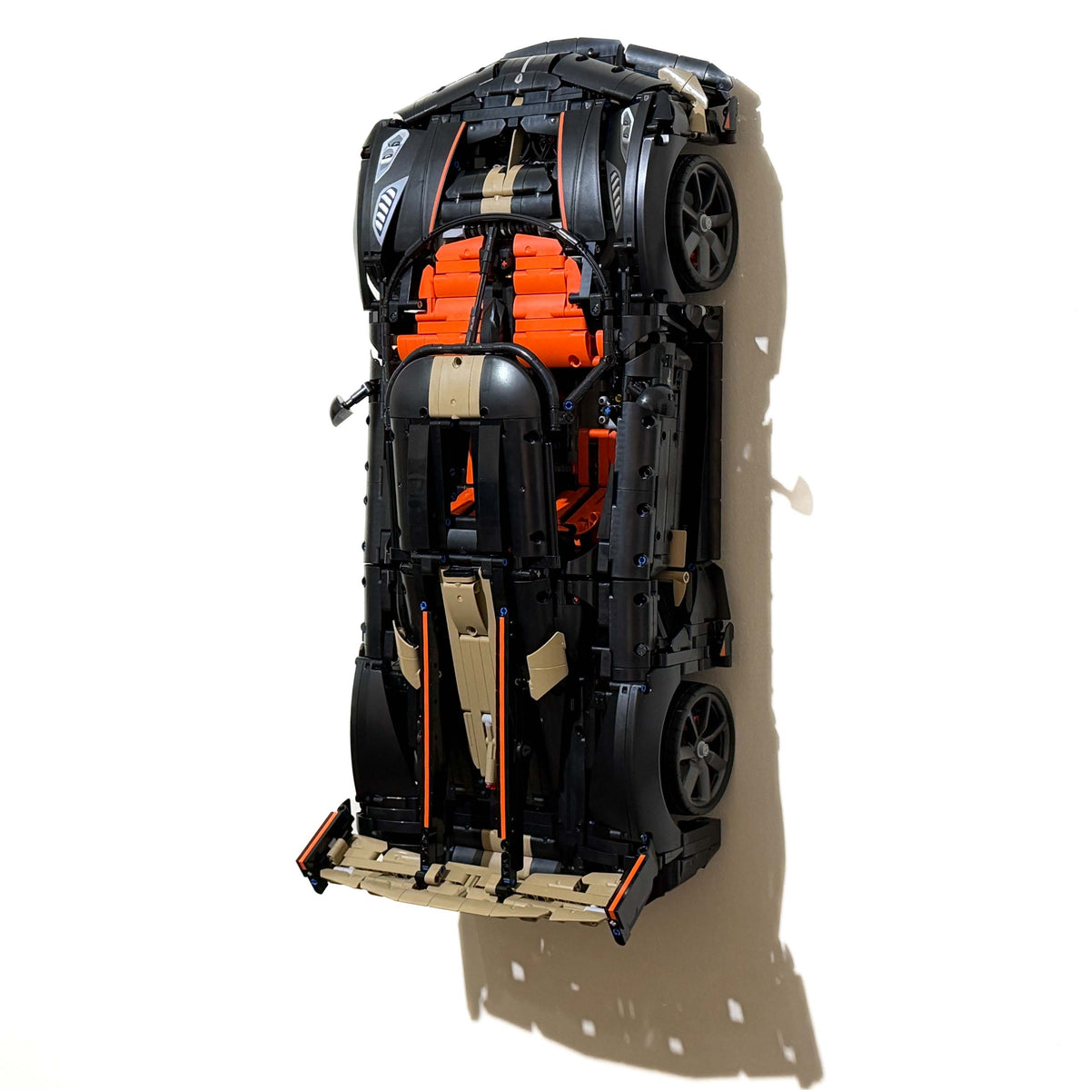 LEGO Technic Koenigsegg Sadair's Spear Megacar 42232 displayed vertically on a wall.